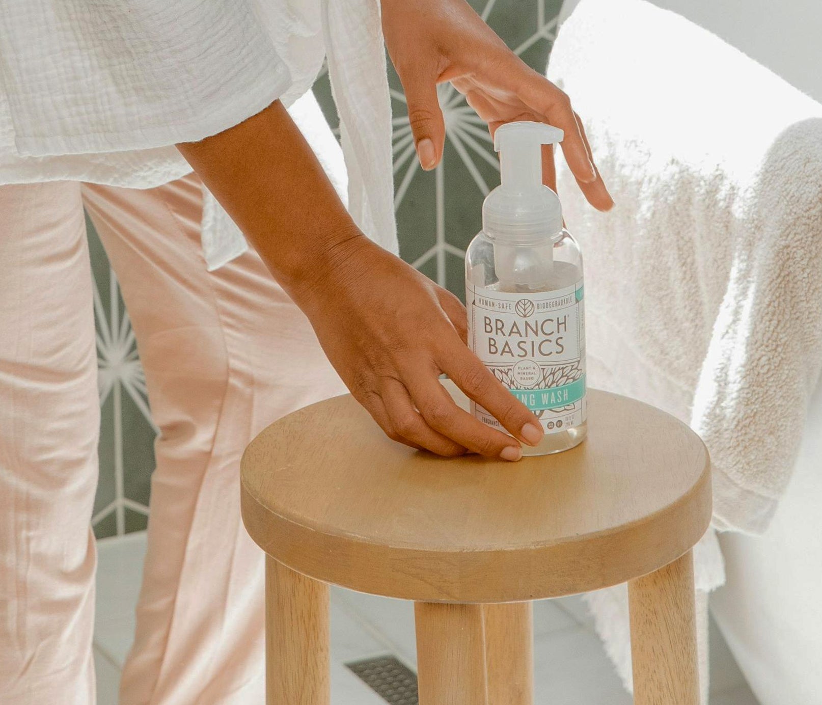 A single Plastic Foaming Bottle placed on a wooden stool. - View 9
