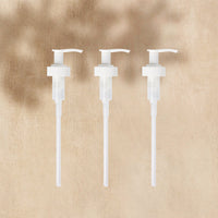 A trio of plastic Pumps for Glass Gel Hand Soap bottles, displayed on a neutral background. - Thumbnail View 1
