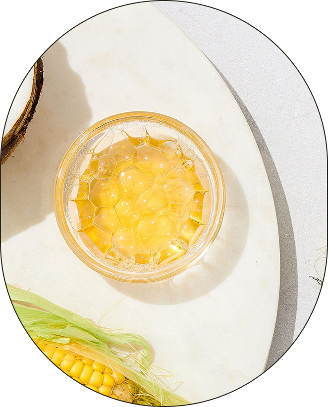 A bowl of Decyl Glucoside, positioned against a neutral-grey background.
