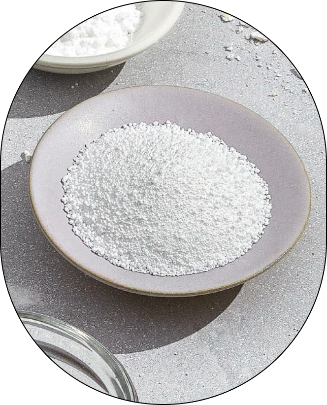 A small bowl containing Sodium Percarbonate, positioned against a neutral background.
