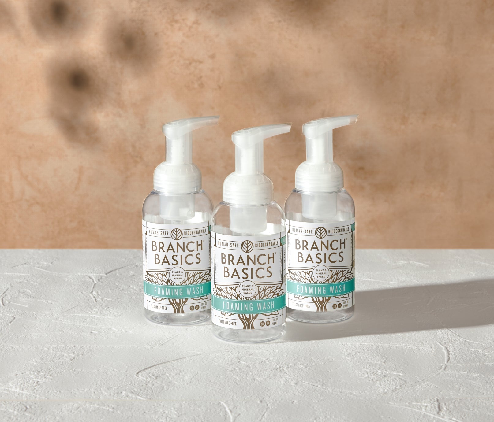 A trio of refillable Plastic Foaming Wash Bottles, displayed on a white surface and neutral background. - View 2
