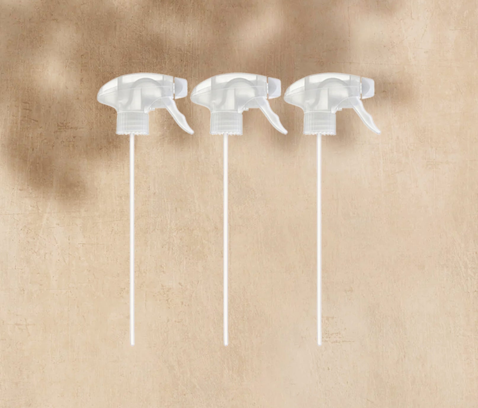 A trio of Bottle Spray Triggers, displayed on a neutral background. - View 2
