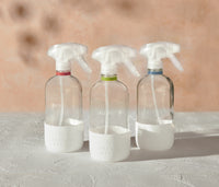 The Glass Bottles Essentials Pack, featuring Bathroom, All-Purpose, and Streak-Free versions of Branch Basics refillable Glass bottles, displayed on a white surface and neutral background. - Thumbnail View 2
