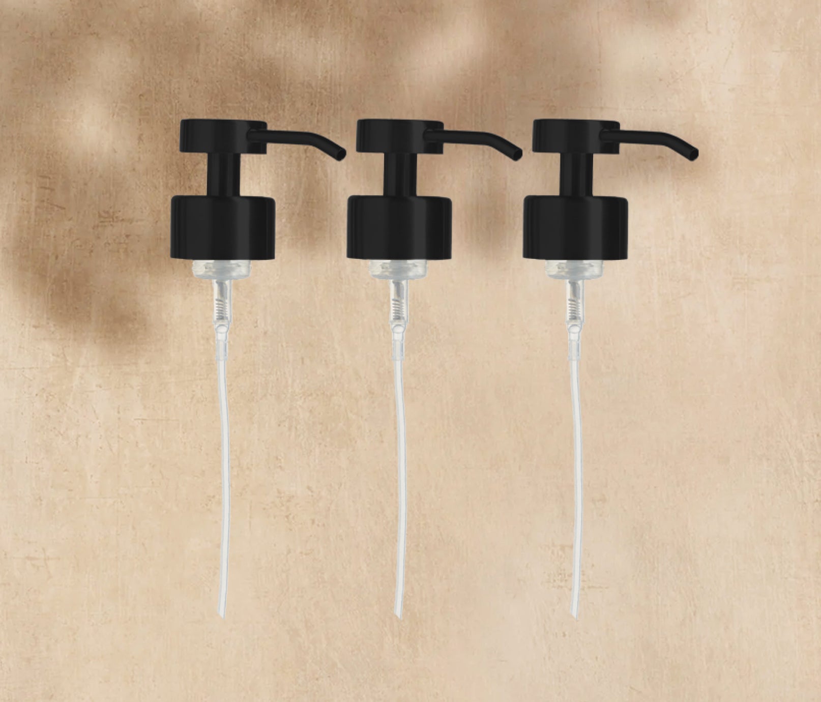 A trio of Matte Black Foaming Wash Pumps for Glass bottles, displayed on a neutral background. - View 1
