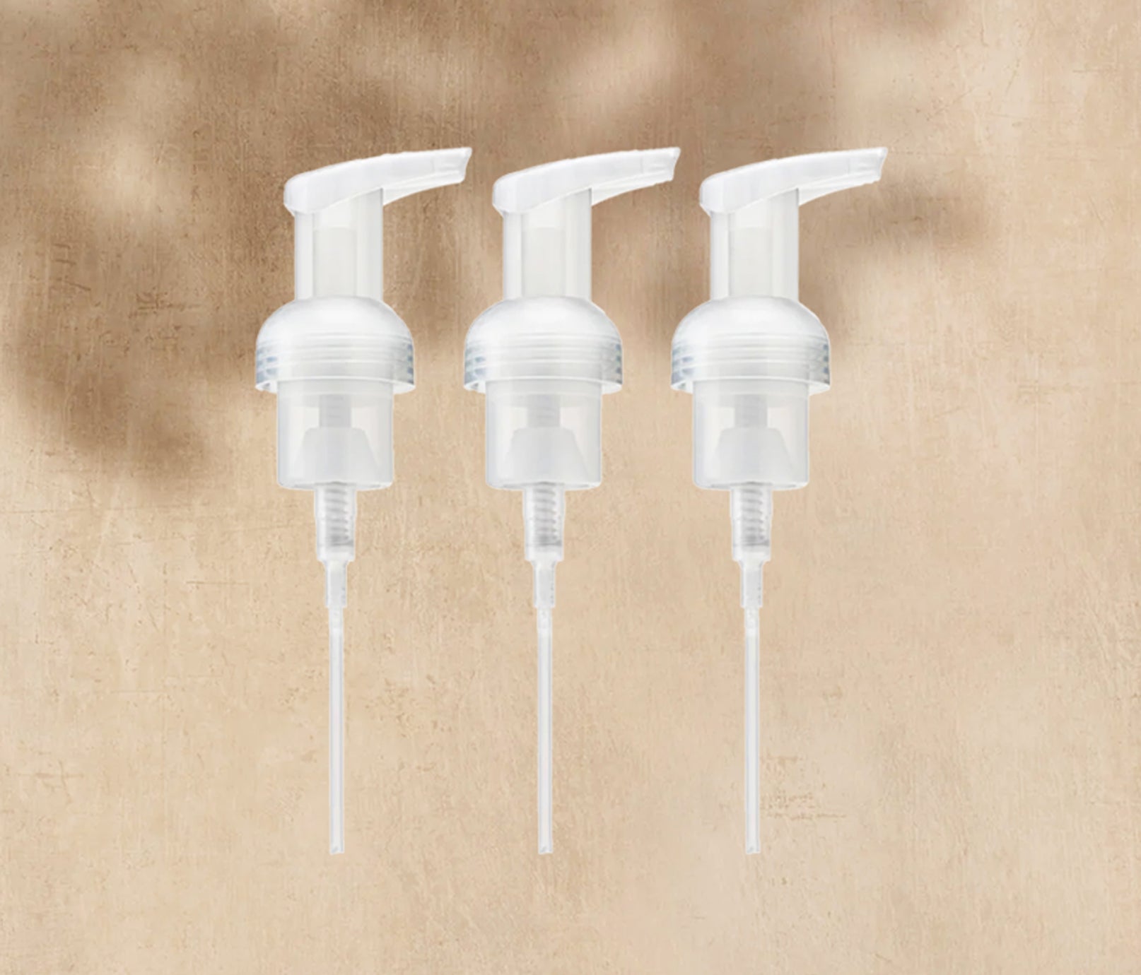 A trio of plastic Foaming Wash Pumps, displayed on a neutral background. - View 2
