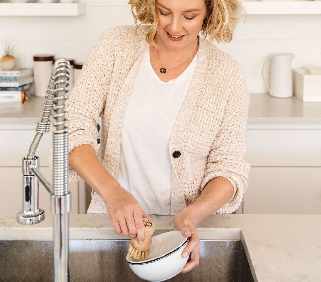 A person standing at a kitchen sink, using a Natural Scrub Brush to scrub dishes. - View 5
