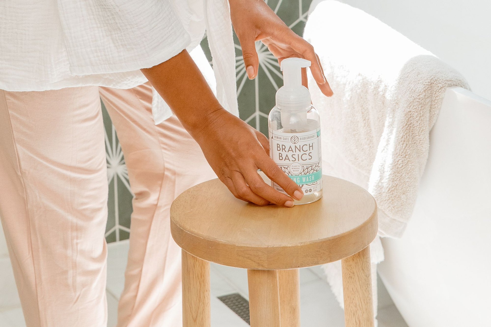 A single Plastic Foaming Bottle placed on a wooden stool. - View 3
